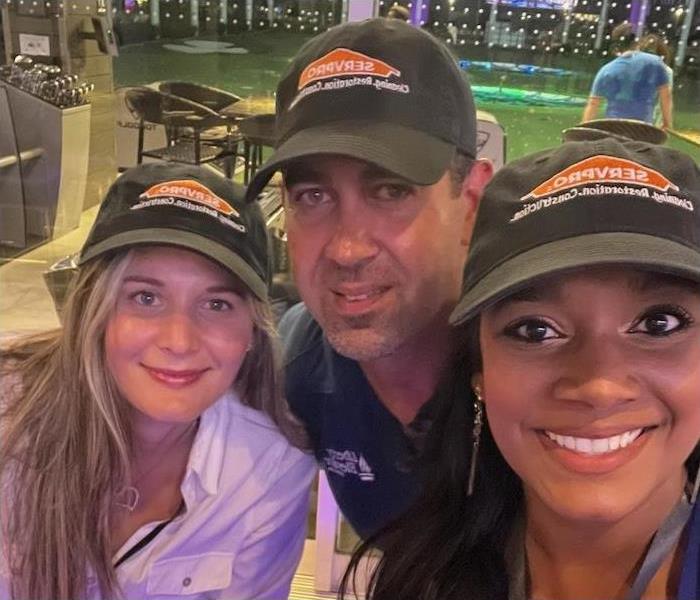 three SERVPRO employees at a golf facility
